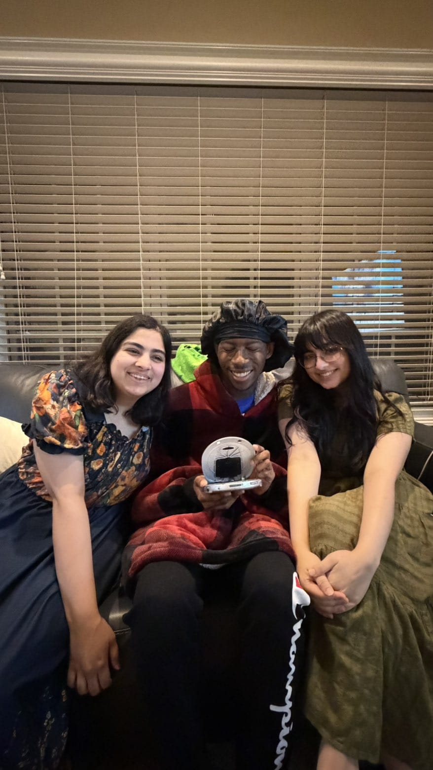 three people on a couch posing together