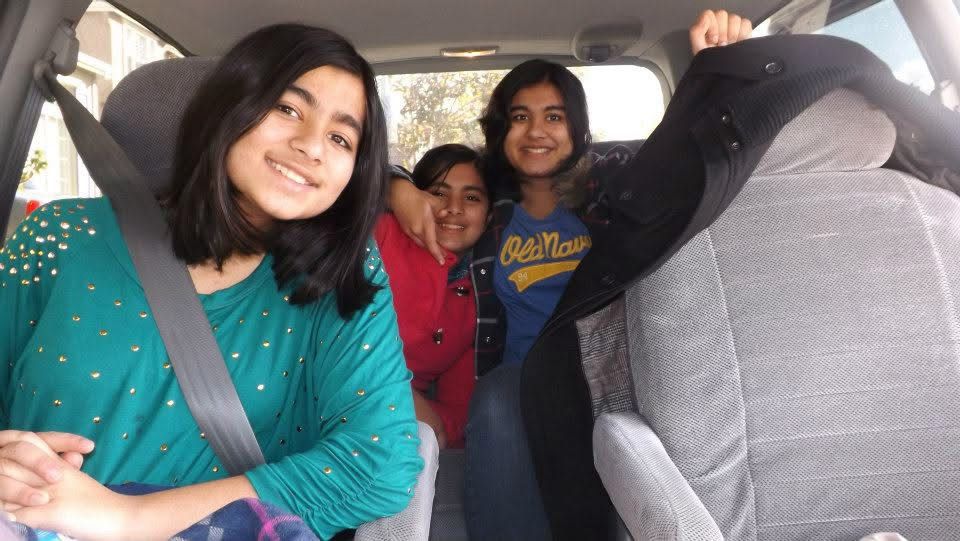 three people sitting in a car